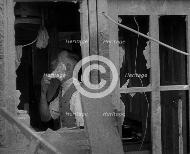 A Man Shaving in a Bombed Out House, 1940. Creator: British Pathe Ltd.