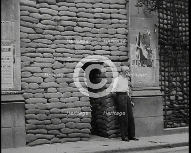 A Man Standing Outside the Frontage of a Building Obscured By Sandbags Next To an..., 1937. Creator: British Pathe Ltd.