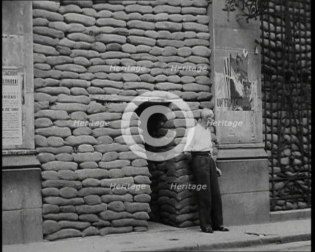 A Man Standing Outside the Frontage of a Building Obscured By Sandbags Next To an..., 1937. Creator: British Pathe Ltd.
