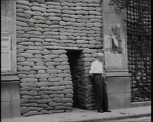 A Man Standing Outside the Frontage of a Building Obscured By Sandbags Next To an..., 1937. Creator: British Pathe Ltd