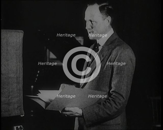 A Man Reading from a Book for the British Broadcasting Corporation, 1922. Creator: British Pathe Ltd.