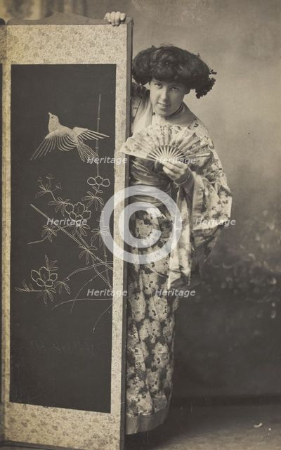 A man wearing a kimono posing from behind a screen, 1906. Creator: Unknown.