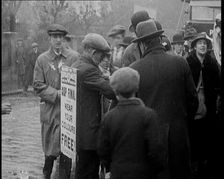 A Man Wearing a Sandwich Board Advertising Pathe Gazette Reading Cup Final Wear Your..., 1921. Creator: British Pathe Ltd