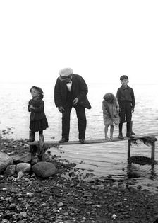 A man with three children on a jetty, Landskrona, Sweden, 1910