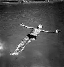 A man takes a refreshing dip in a swimming pool during the hot summer, Sweden, 1943. Creator: Karl Sandels