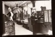 A man uses the clocking in machine, Rowntree factory, Yorkshire, 1929