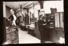 A man uses the clocking in machine, Rowntree factory, Yorkshire, 1929