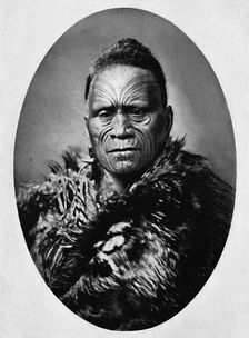 A Maori chief with elaborately tattooed face and weather cloak, 1902. Artist: Josiah Martin