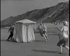 A Male Actor With a Moustache and Bowler Hat Being Chased Around a Changing Tent On a Beach...,1920s Creator: British Pathe Ltd