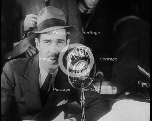 A Male American Civilian in a Press Room Speaking at a Microphone That Has the Words NBC..., 1930s. Creator: British Pathe Ltd.