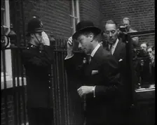 A Male British Police Officer Saluting King George VI, the British Monarch who is Exiting..., 1939. Creator: British Pathe Ltd