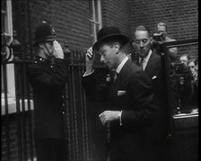 A Male British Police Officer Saluting King George VI, the British Monarch who is Exiting..., 1939. Creator: British Pathe Ltd