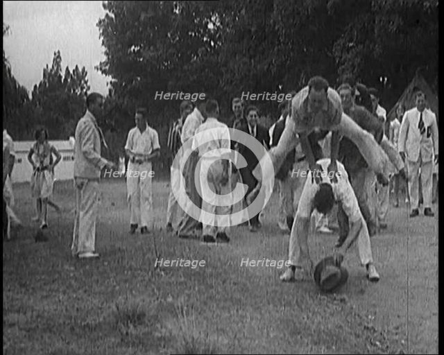 A Male Civilian Leapfrogging over Another Male Civilian Outdoors in a Holiday Camp, 1920. Creator: British Pathe Ltd.