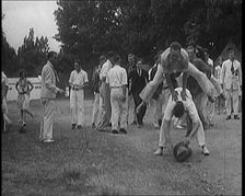 A Male Civilian Leapfrogging over Another Male Civilian Outdoors in a Holiday Camp, 1920. Creator: British Pathe Ltd
