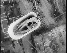 A Male Civilian Sitting in a Bath Lifted Off the Ground By a Hot Air..., 1920s. Creator: British Pathe Ltd