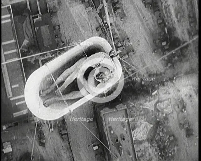 A Male Civilian Sitting in a Bath Lifted Off the Ground By a Hot Air..., 1920s. Creator: British Pathe Ltd.