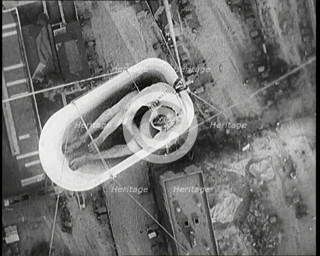 A Male Civilian Sitting in a Bath Lifted Off the Ground By a Hot Air..., 1920s. Creator: British Pathe Ltd.