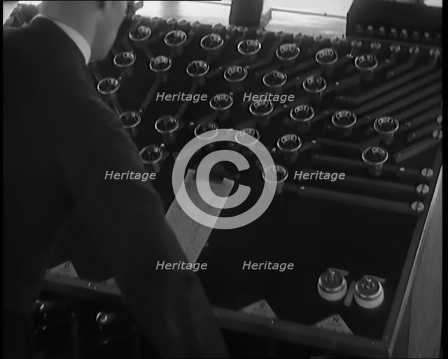 A Male Civilian Using System of Levers and Cogs To Make the Automated Railway Marshalling..., 1931. Creator: British Pathe Ltd.