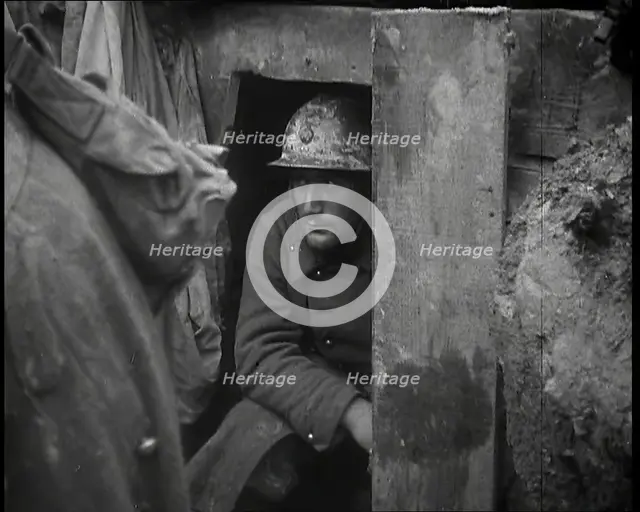A Male French Soldier Sitting in a Doorway Dug into the Side of a Trench, 1939. Creator: British Pathe Ltd.