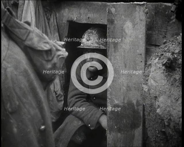 A Male French Soldier Sitting in a Doorway Dug into the Side of a Trench, 1939. Creator: British Pathe Ltd.