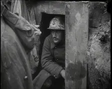 A Male French Soldier Sitting in a Doorway Dug into the Side of a Trench, 1939. Creator: British Pathe Ltd