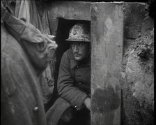 A Male French Soldier Sitting in a Doorway Dug into the Side of a Trench, 1939. Creator: British Pathe Ltd