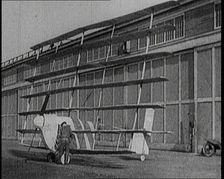 A Male Pilot Getting Into an Early Seven Winged Plane, 1922. Creator: British Pathe Ltd