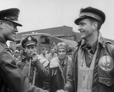 A Male Pilot Shaking Hands with an Officer, whilst other Pilots are Looking On, 1943-1944. Creator: British Pathe Ltd