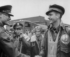 A Male Pilot Shaking Hands with an Officer, whilst other Pilots are Looking On, 1943-1944. Creator: British Pathe Ltd