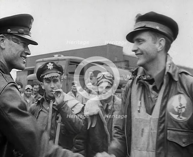 A Male Pilot Shaking Hands with an Officer, whilst other Pilots are Looking On, 1943-1944. Creator: British Pathe Ltd.