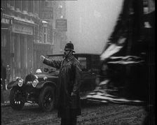 A Male Police Officer Directing the Traffic in the Snow, Facing the Camera, 1920s. Creator: British Pathe Ltd