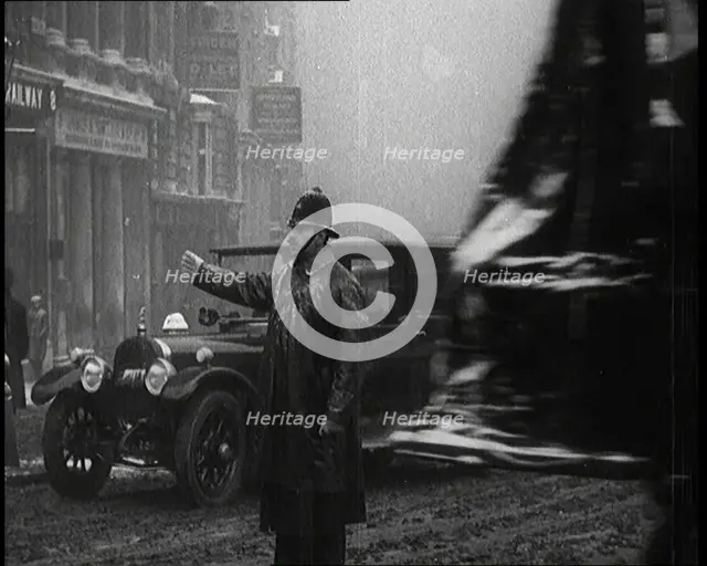 A Male Police Officer Directing the Traffic in the Snow, Facing the Camera, 1920s. Creator: British Pathe Ltd.