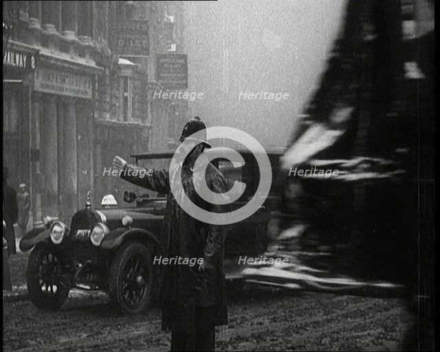A Male Police Officer Directing the Traffic in the Snow, Facing the Camera, 1920s. Creator: British Pathe Ltd.