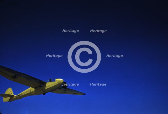 A Marine Corps glider being towed by a power plane from Page Field, at Parris Island, S.C., 1942. Creator: Alfred T Palmer.