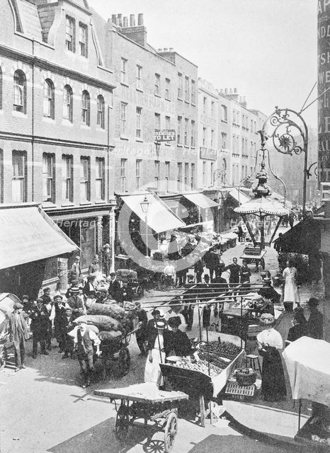 A market in Little Earl Street, looking east, East London. Creator: Unknown.