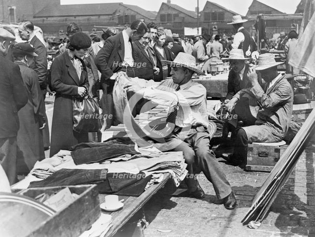 A market stall in Caledonian Market, Islington, London, 1930s. Creator: John H Stone.