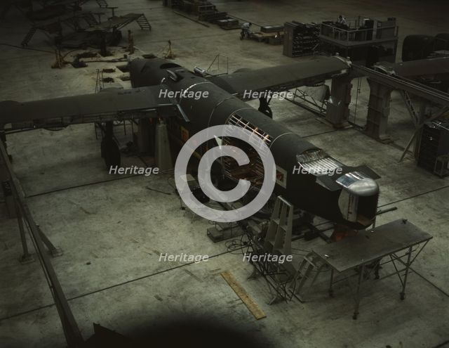 A mating operation on a transport plane...Consolidated Aircraft Corp..., Fort Worth, Texas, 1942. Creator: Howard Hollem.