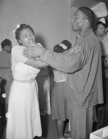 A member of the St. Martin's Spiritual Church, receiving the final..., Washington, D.C., 1942. Creator: Gordon Parks