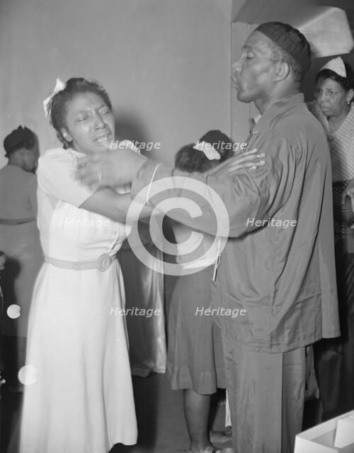 A member of the St. Martin's Spiritual Church, receiving the final..., Washington, D.C., 1942. Creator: Gordon Parks.