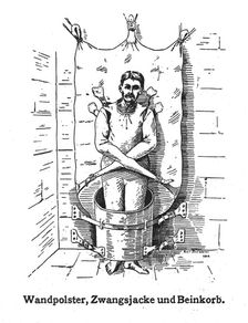 A mentally ill patient in a strait-jacket attached to the wall and a strange barrel..., 1908. Creator: Unknown