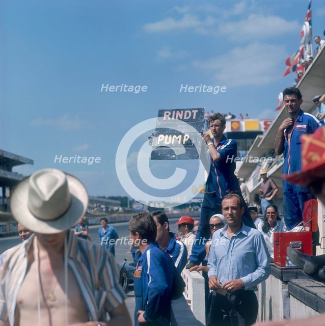 A mechanic holding up a sign, French Grand Prix, Le Mans, France, 1967. Artist: Unknown