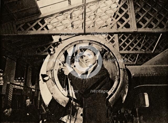 A metal worker with automatic drill stripping an engine casing, 1940. Artist: Unknown