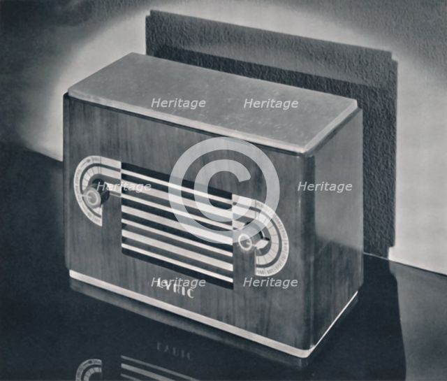 'A midget radio cabinet in wood veneer, with aluminum grill and dials', 1935. Artist: Dana Merrill.