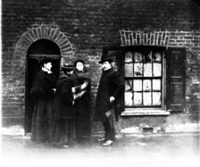 A missionary and three women, London, early 20th century. Creator: John Galt