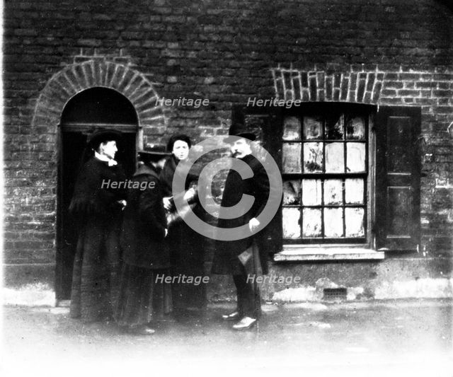 A missionary and three women, London, early 20th century. Creator: John Galt.