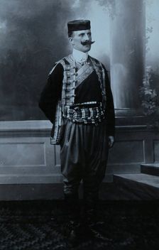 A Montenegrin man wearing national dress and a Montenegrin cap. Creator: Unknown