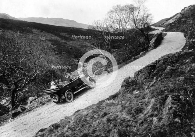 A Morris Oxford climbing a steep hill in the Lake District, Cumbria, (c1920s?). Artist: Unknown