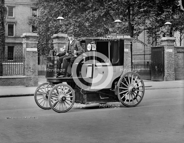 A motor cab and driver, London, c1900. Artist: York & Son