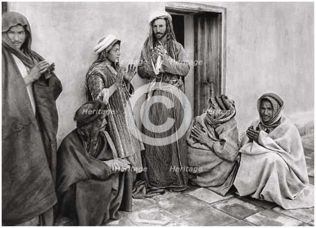 A mullah teaching a prayer to a young man, Iraq, 1925.Artist: A Kerim