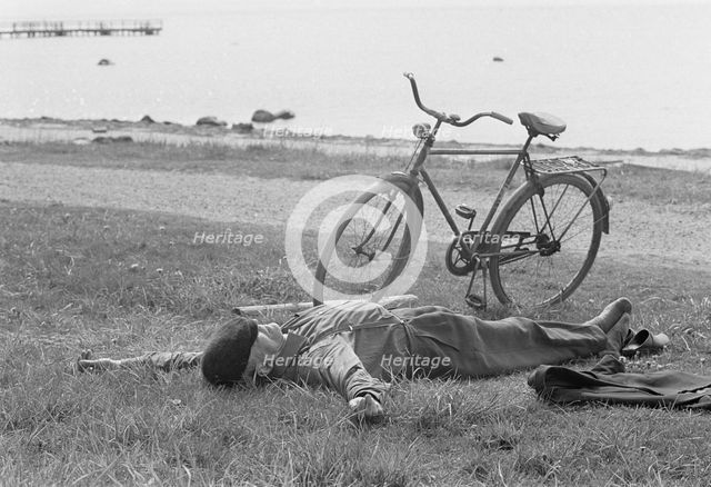 A nap by the sea at Borstahusen, Landskrona, Sweden, 1967. Creator: Unknown.